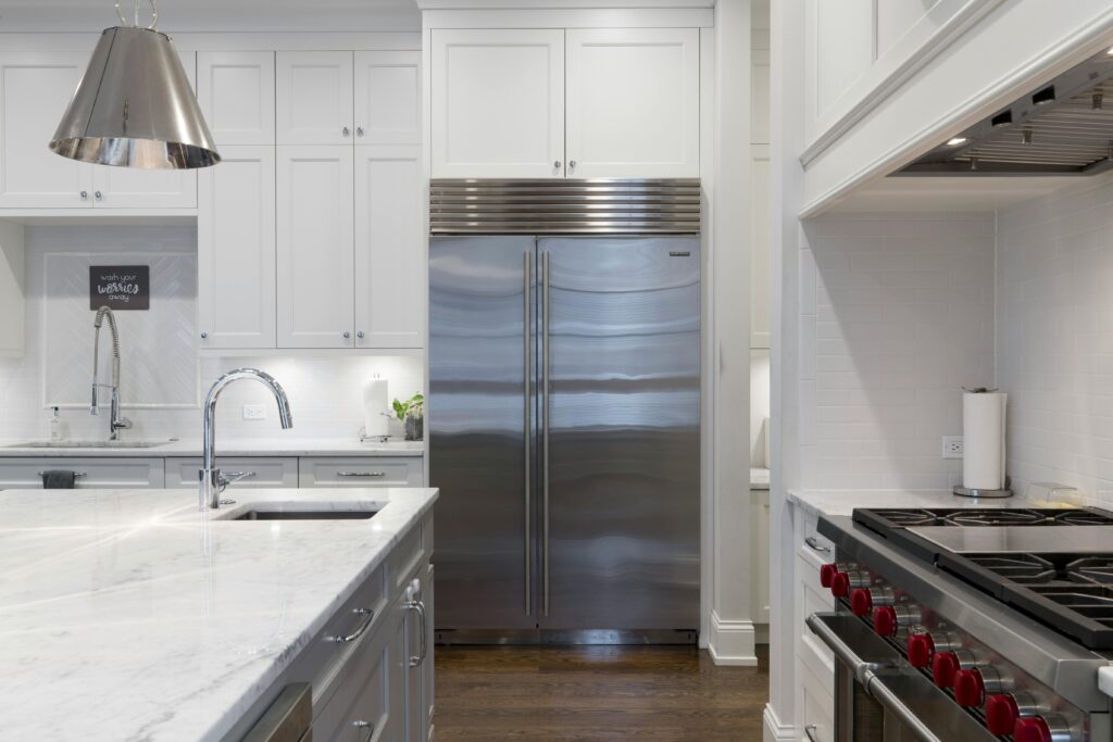 pexels-photo-2343467-2343467 A sleek modern kitchen featuring stainless steel appliances and marble countertops.